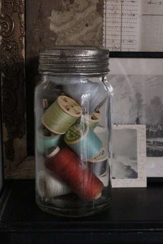 Old Kilner Jar Filled With Antique Cotton Reels in Natural Autumnal Tones