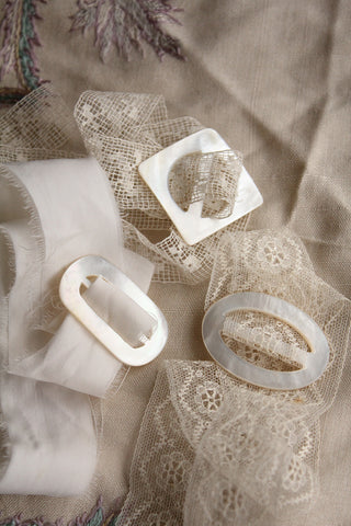 A Trio of Mother of Pearl Buckles on Silk & Lace
